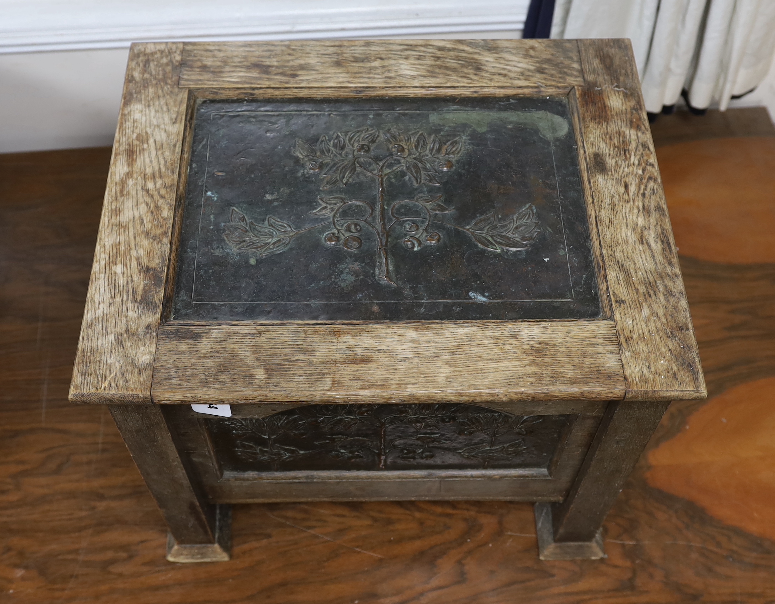 An Arts and Crafts oak and embossed copper coal box, width 54cm, depth 43cm, height 46cm
